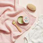 natural baby eczema treatment balm with spoon and cloth for gentle application