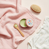 natural baby eczema treatment balm with spoon and cloth for gentle application